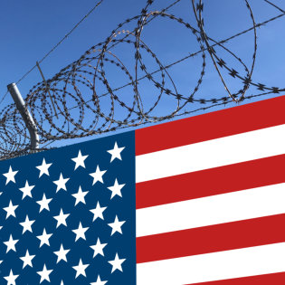 fence with barbed wire and the american flag below